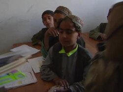 MS PAN TU TD Soldier distributing books in school / Musa Qala, Helmand Province, Afghanistan. Stock Footage
