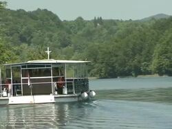 WS PAN Boat moving on lake, UNESCO World Heritage Site / Plitvice, Croatia   Stock Footage