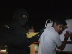 April 3 2009 MONTAGE Mexican police officers frisking and arresting people on street, Juarez, Chihuahua, Mexico, AUDIO Stock Footage