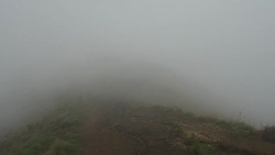 Group of Tourists Disappearing in Mist on the Rim of Volcano Crater Stock Footage