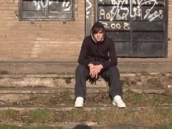 Youth / Hoody sat on steps - HD &amp; PAL Stock Footage