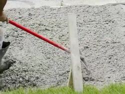 CU Shot of Workman leveling freshly poured concrete / Valparaiso, Indiana, United States Stock Footage