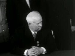 B/W 1950s Nikita Khrushchev sitting at table looking to side / newsreel Stock Footage