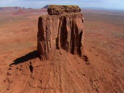 Aerial low over top of East Mitten Butte / Monument Valley Stock Footage