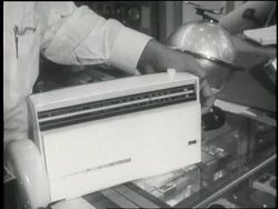 A man listens to a transistor radio. News Clip