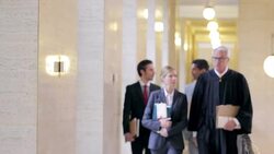 Judge and lawyers walking in courthouse Stock Footage