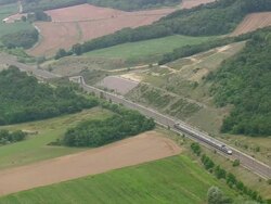 WS AERIAL TS Shot of express train running track besides farm fields / Rhone Alpes, France Stock Footage