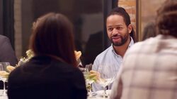 MS Smiling man sitting in discussion with friends during dinner party Stock Footage