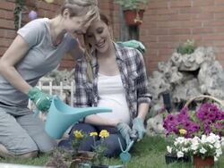 HD: Lesbian Couple Gardening In A Backyard. Stock Footage