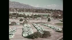 WS HA PAN View of parking lot of sports stadium with mountain in background / United States Stock Footage