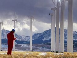 Row of Wind Generators Against a Mountain Backdrop Stock Footage