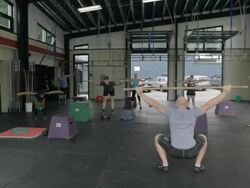 Wide frame. Dustin demonstrates dowl squat to class. Stock Footage