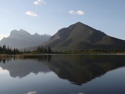 PAN across mountain lake st sunrise Stock Footage