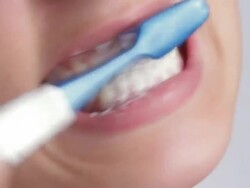 Cheerful young woman brushing teeth. Stock Footage