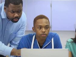Instructor Assists Students with Laptop Computer Stock Footage