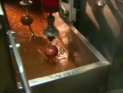 Medium static - Mechanical arms dip apples into a bin of caramel /  Missouri, United States Stock Footage