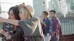 Playful young women taking selfie at urban rooftop party Stock Footage