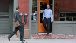 Business owner meets financial advisor outside of downtown restaurant Stock Footage