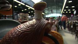 Cowboy hats and saddles for sale at trade fair News Clip