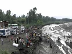 Cars parked by river and people trying to cross river after bridge fell Stock Footage