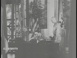1937: COMMONWEALTH of the PHILIPPINES: Field Marshall of the Philippines (retired US General) Douglas MacArthur in office using telephone, at desk w/ Chief of Staff Lt. Colonel Dwight D. Eisenhower standing, MacArthur handing papers, using telephone. Instructional Video