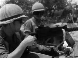 B/W 1967 SIDE VIEW 2 soldiers shooting machine gun in desert in Six Day War / newsreel Stock Footage