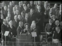 U.S. Chief Justice Earl Warren administers the oath of inauguration to U. S. President Elect Lyndon B. Johnson. News Clip