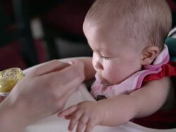 Slow motion view of baby being fed from a spoon. Stock Footage