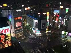 WA High angle view of crowded intersection at night, surrounded by buildings with signs, billboards and video screens, Tokyo Stock Footage