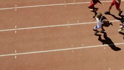 Male relay runners passing batons on track Stock Footage