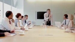 Businessman leading meeting in conference room Stock Footage