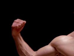 Close up muscular man flexing bicep / lowering arm / London Stock Footage