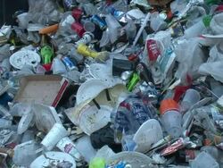Medium Close Up - Trash pile being pushed by garbage truck / New Orleans Louisiana Stock Footage