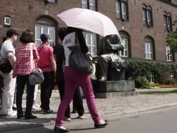 WS View of tourist crowd near HC Anderson statue and building / Copenhagen, Denmark Stock Footage