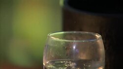 Alcoholic drinks being poured at a bar News Clip