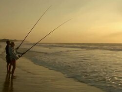 WS View of Fishermen on beach at sunset, St Lucia / Kwazulu-Natal, South Africa Stock Footage