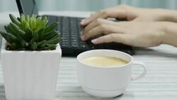 TypingAndDringkingCoffee Stock Footage