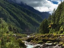 Panning shot of Time-lapse of a river and a trail in a Himalayan valley. Stock Footage