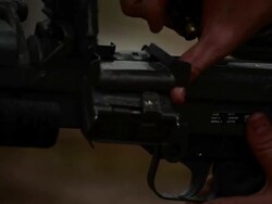 Soldier repeatedly shooting gun Stock Footage