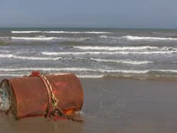 Large Tank Washed Up on Beach Stock Footage