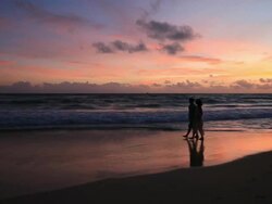 Good Looking Young Couple walking by the Sea at Sunset Stock Footage