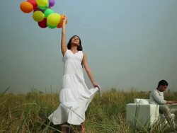 Young woman playing with balloons in the forest Stock Footage