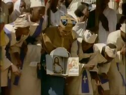 MCU Group of African clerics and children in traditional dress, kneel to pray, holding religious paraphernalia, Ethiopia, Africa Stock Footage