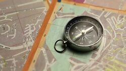 The compass indicates the right path on map of city in italy Stock Footage