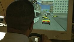 A Metro Transit Authority worker uses a computer screen to simulate the driving of a taxicab. Stock Footage