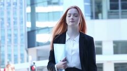 City girl, walking, carrying documents. Stock Footage