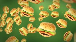 Cheeseburgers float in front of a green background. Stock Footage
