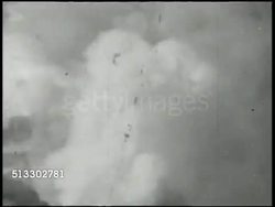 1942: BATTLE OF THE CORAL SEA:  VS Imperial Japanese Navy battleships firing anti-aircraft artillery cannons, smoke in sky. XWS Damaged, smoking, Japanese carrier at sea, Pacific Ocean (sunk, sinking). World War II, WWII, Pacific Front Instructional Video