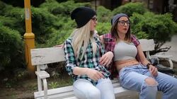 Girlfriends  at the park on the bench Stock Footage