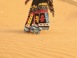 Rajasthani woman walking on desert, Sam Desert, Jaisalmer, Rajasthan, India Stock Footage